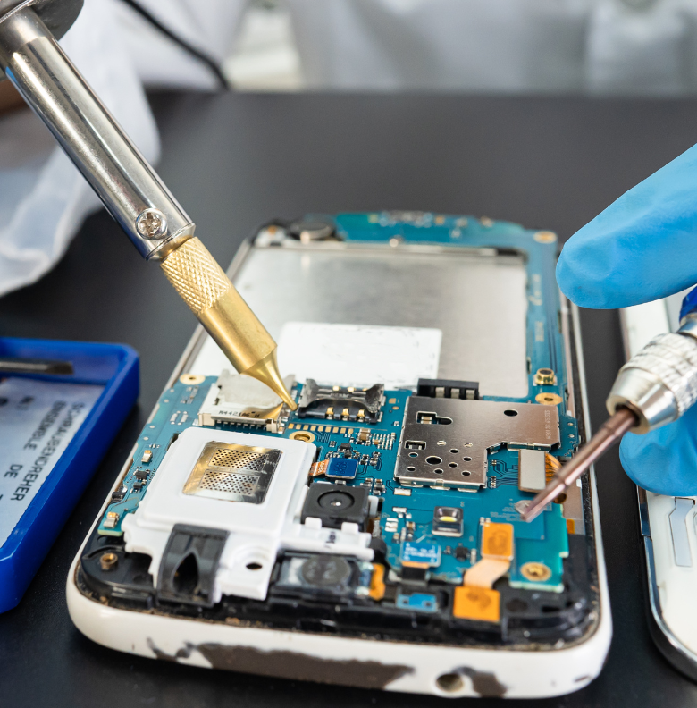 Technician repairing smartphone motherboard